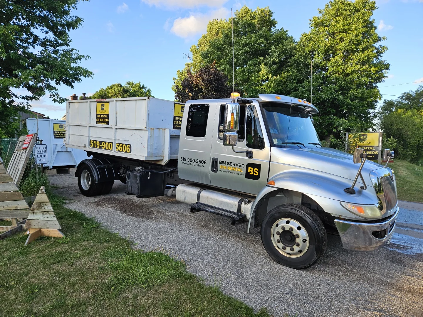 Bin Served delivery truck carrying a rental bin
